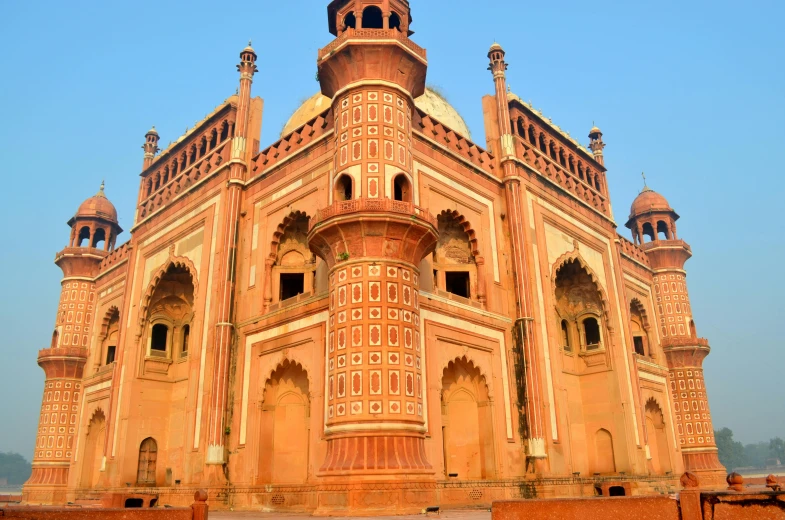 a beautiful bricked building with several windows and pillars