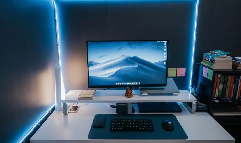 a white desk with a computer monitor and keyboard on top of it