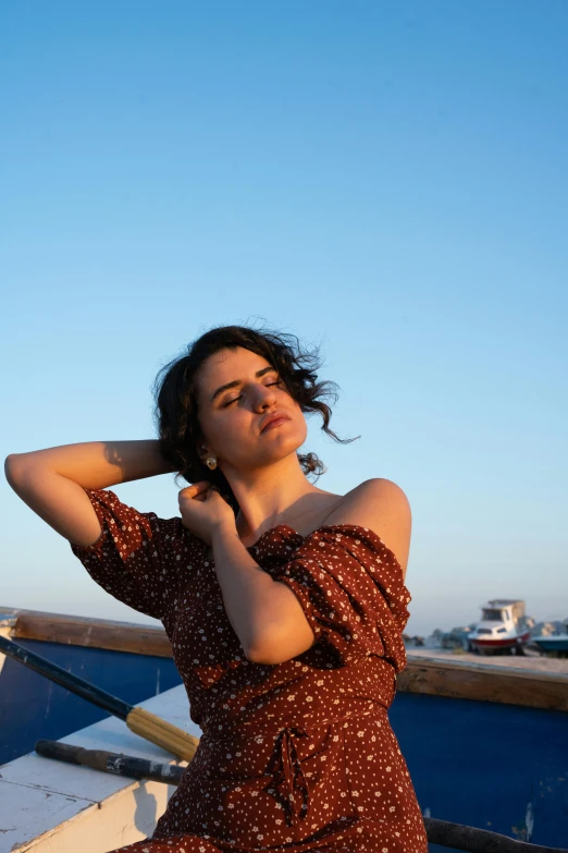 a woman leaning on a rail looking up at the sky