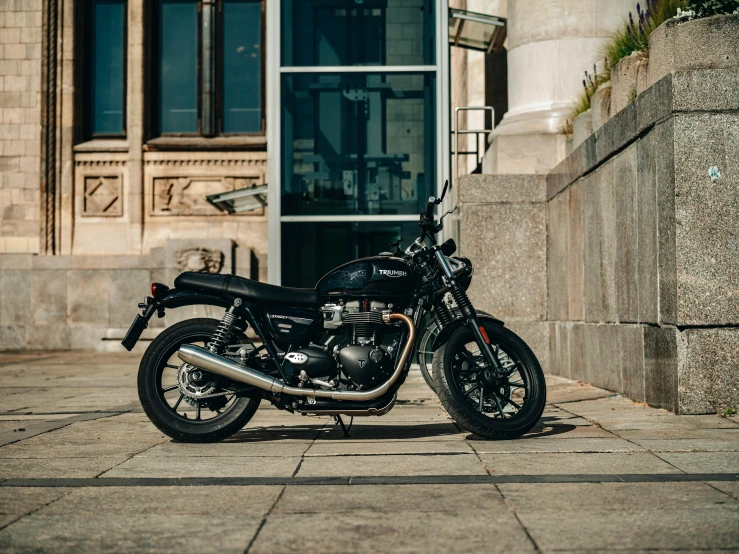 a black motorcycle is parked outside of a building