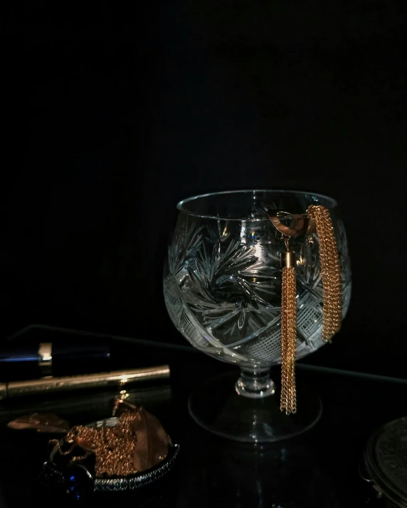 an image of a fancy looking glass with gold jewelry