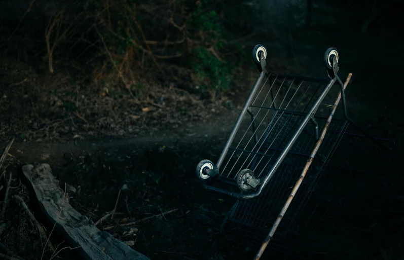 an empty bench with two metal wheels