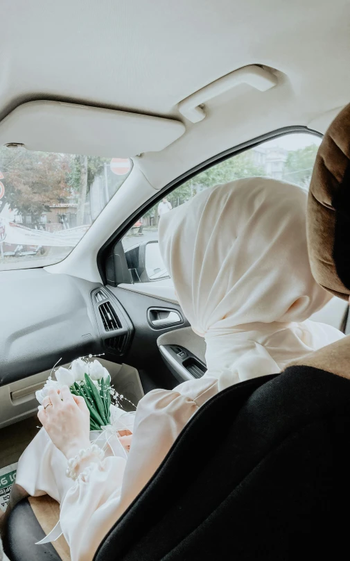 a young person riding in the back seat of a car