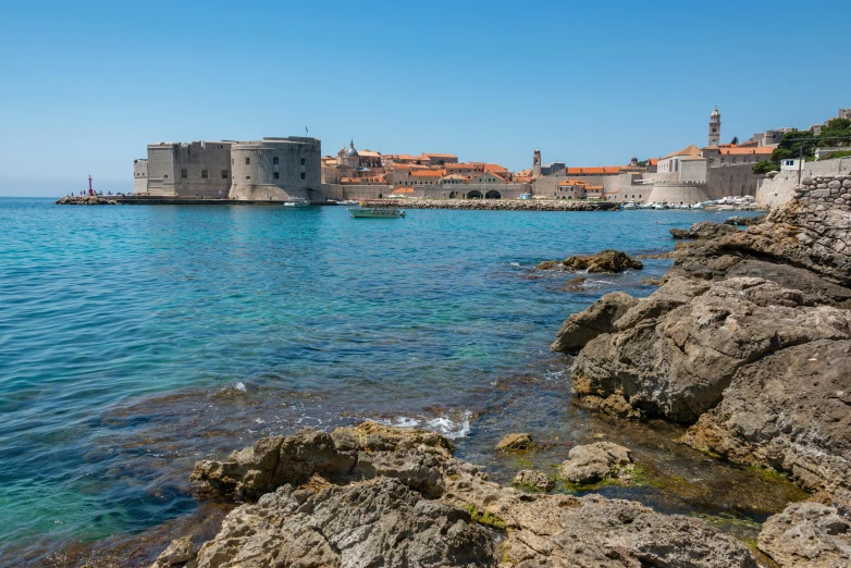 the ocean near a small city with many buildings