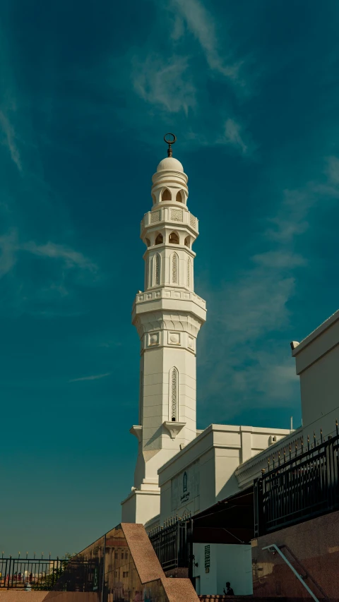 a large white tower next to some buildings