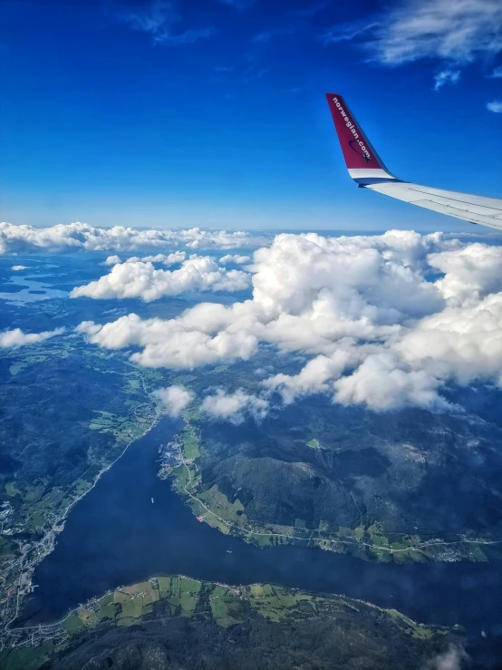 a airplane that is in the air above some clouds