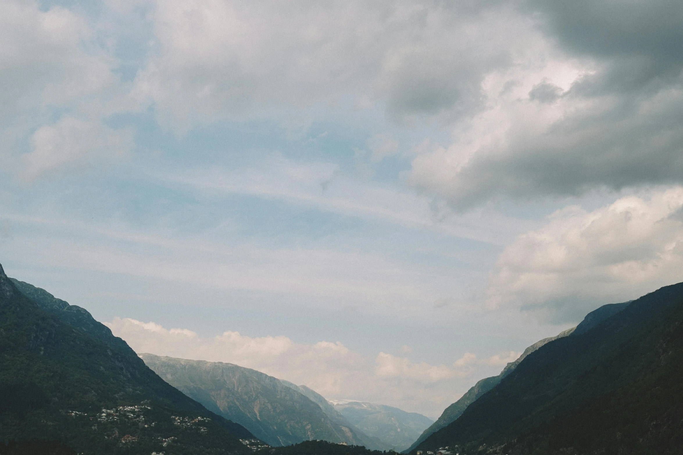 some mountains are shown near the water