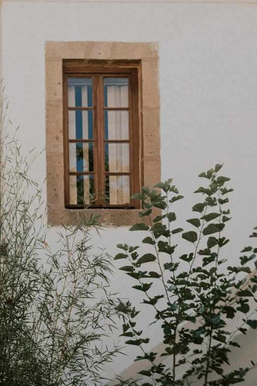 this is an old window in a white stucco wall