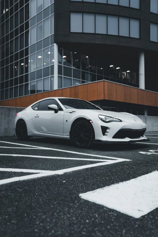 a white sports car parked near a building