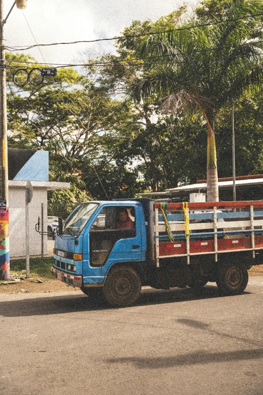 the large blue truck is pulling in to the next stop