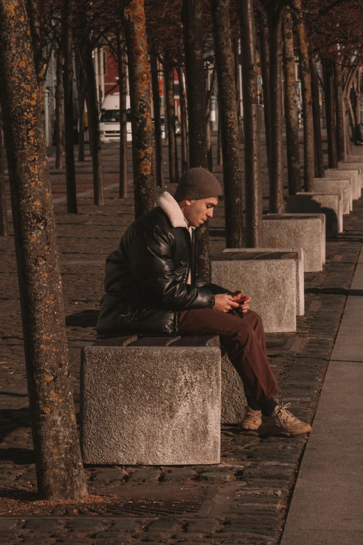 a person sitting in the middle of some benches