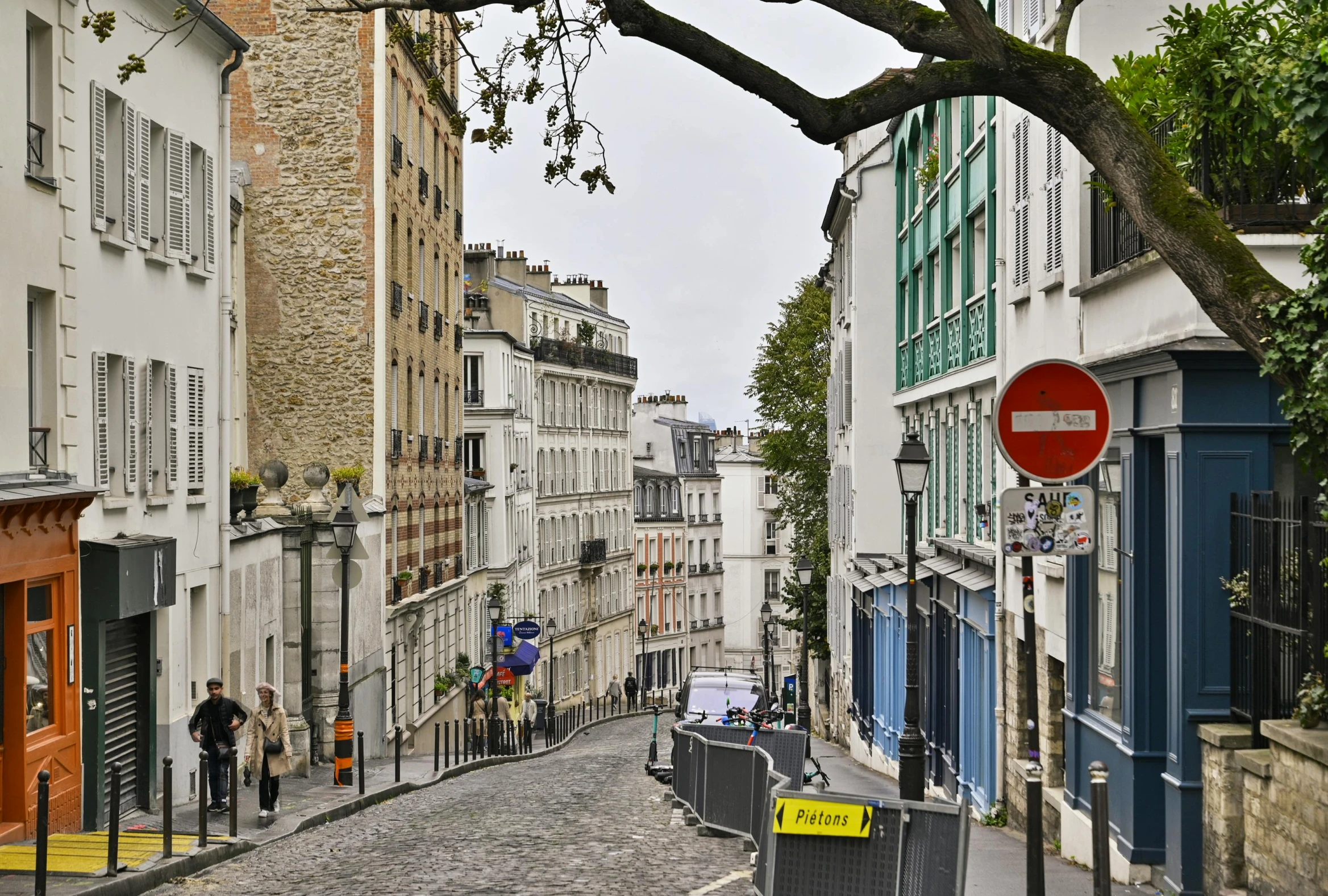 a narrow city street lined with tall buildings