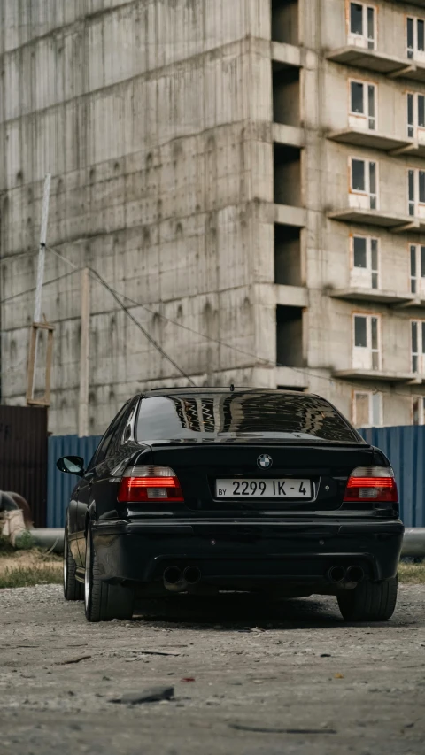 a parked bmw car in front of some large building