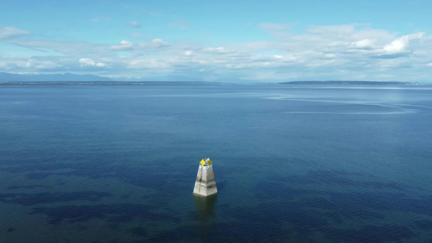 a lighthouse sitting in the middle of some water