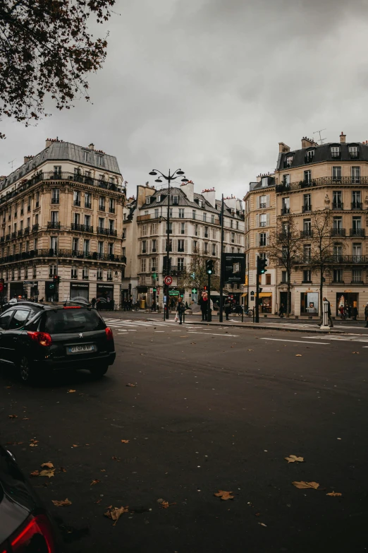 a city street filled with traffic next to tall buildings