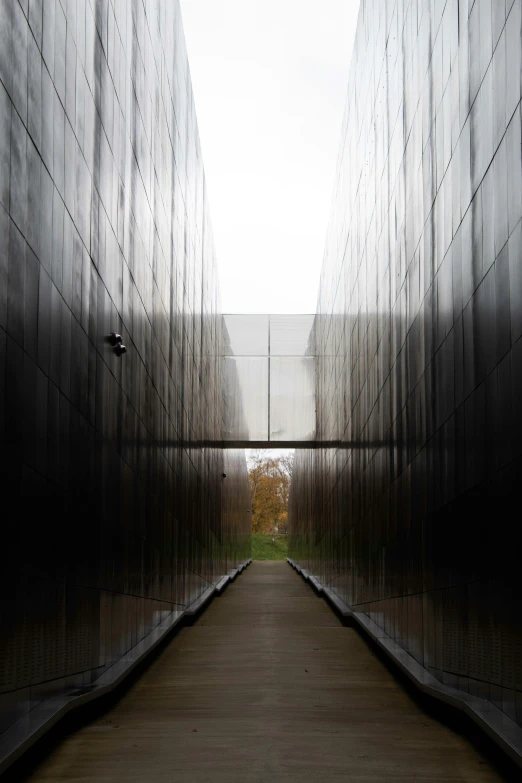 several cube like buildings are lined up along an alley