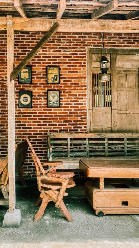 old wooden benches sitting under a covered porch