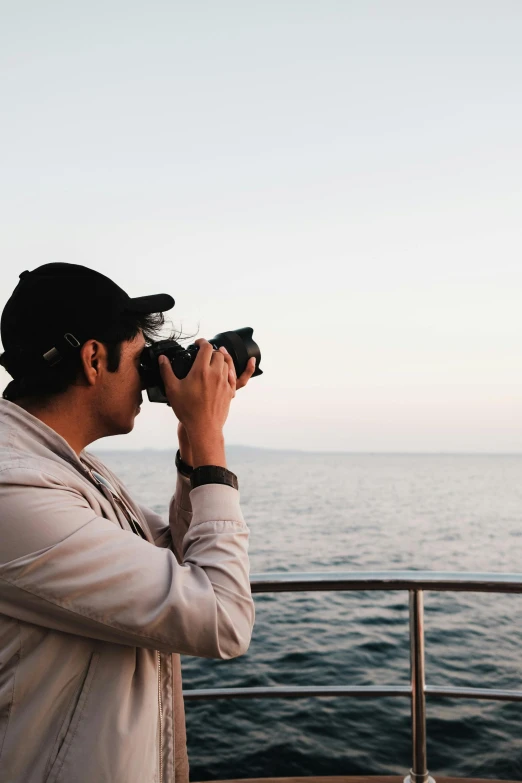 the man is looking at the view with binoculars