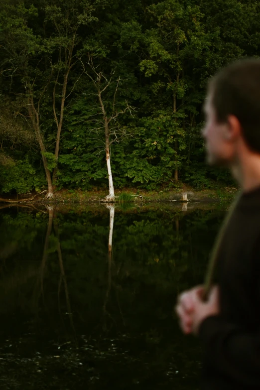 a man stands in the middle of a lake