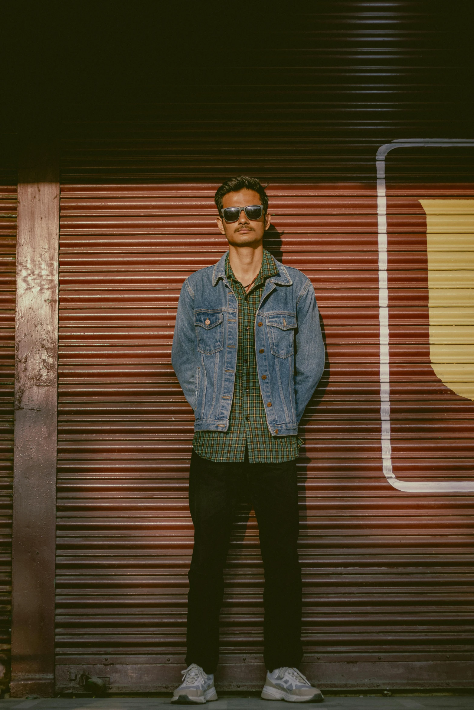 a man is standing near a metal garage door