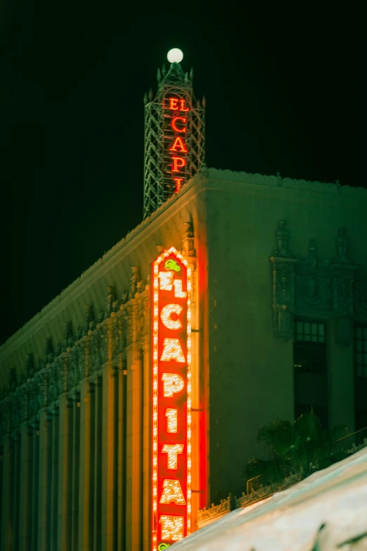 an old building with a lighted sign that says the regal theatre on top