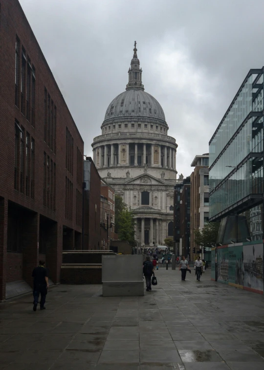 some people walking down a street next to some buildings