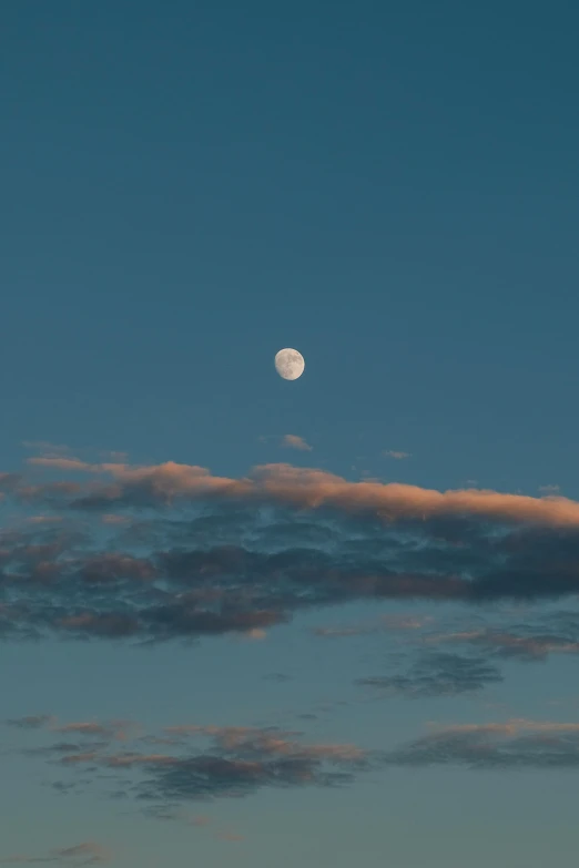 the moon shines in the sky above an island