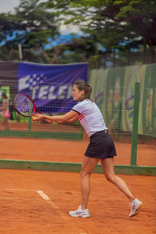 a woman holding a tennis racquet on top of a tennis court