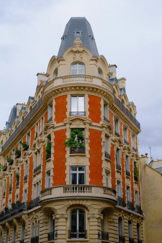 a tall building with orange windows and many windows