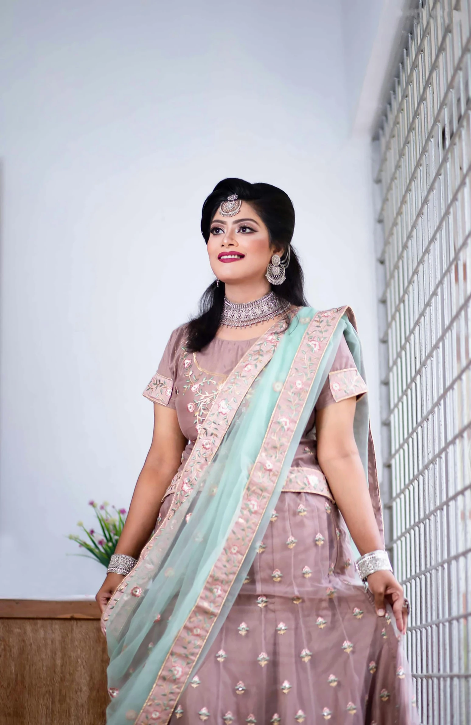 the bride poses for a picture before her big ceremony