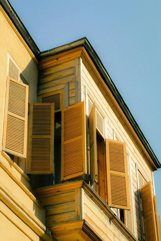 a close up image of a building that has wooden shutters