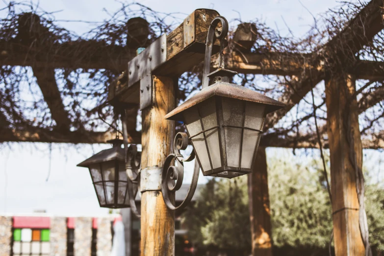 a wooden structure with two light fixtures attached to it