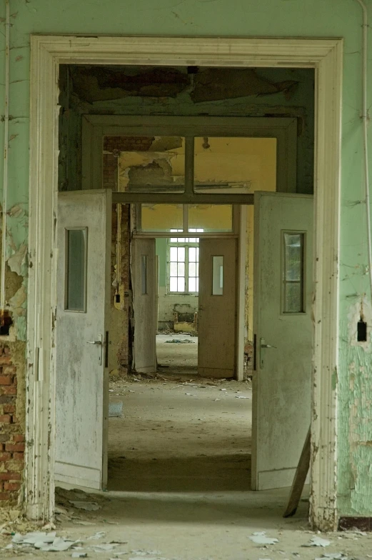 an abandoned building with two doors that have been partially closed
