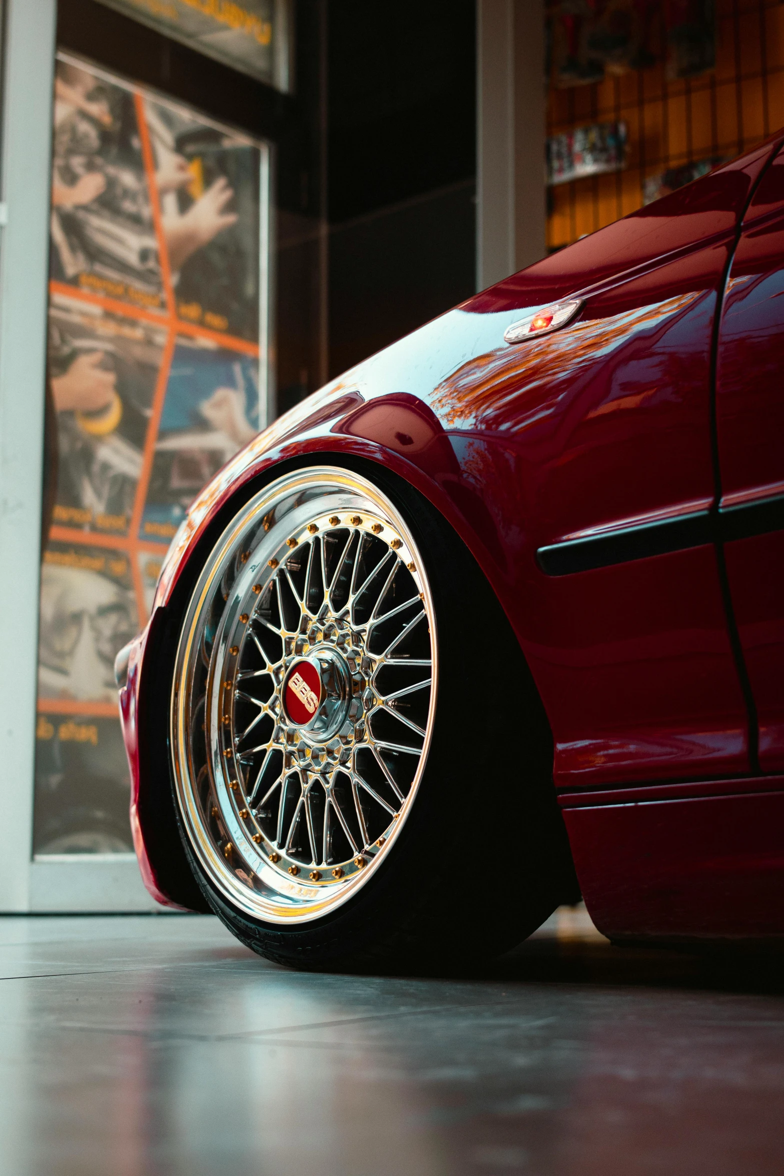 a close up of a sports car tire on the ground