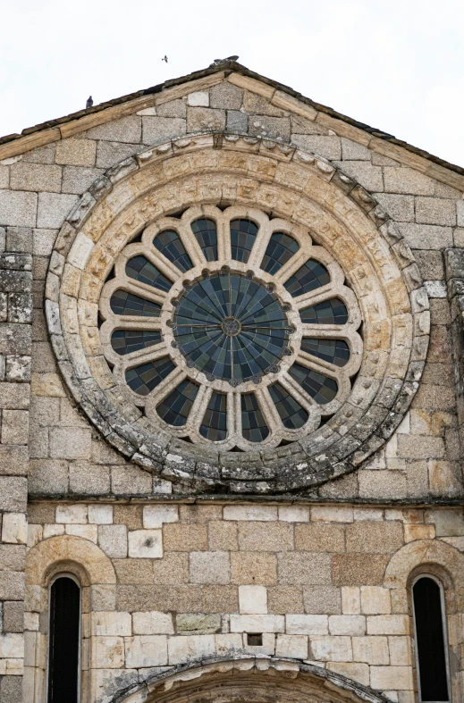 an ancient cathedral with round window and arch