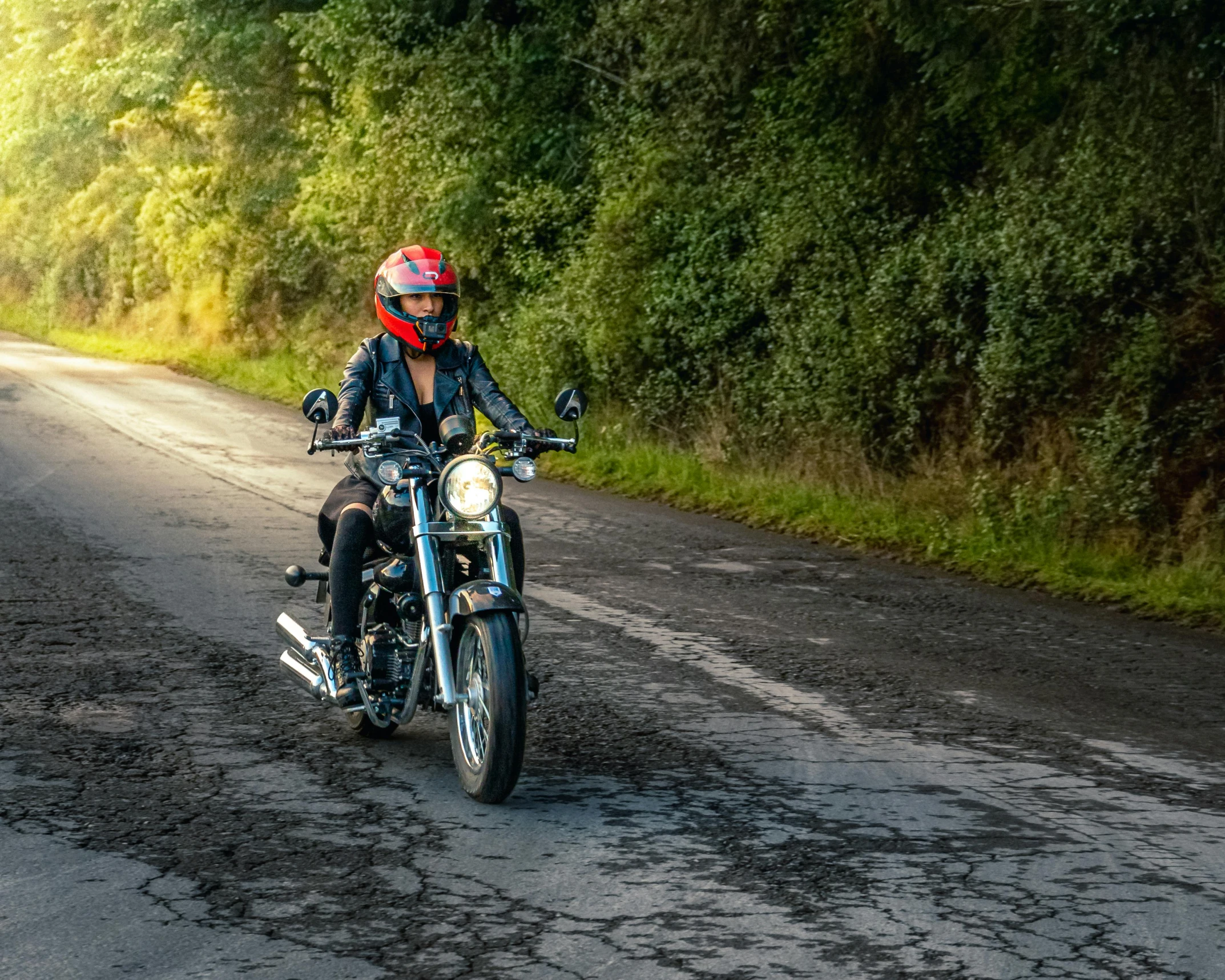 a man rides his motorcycle down the road