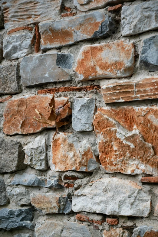 the corner of a wall is made of several different stones