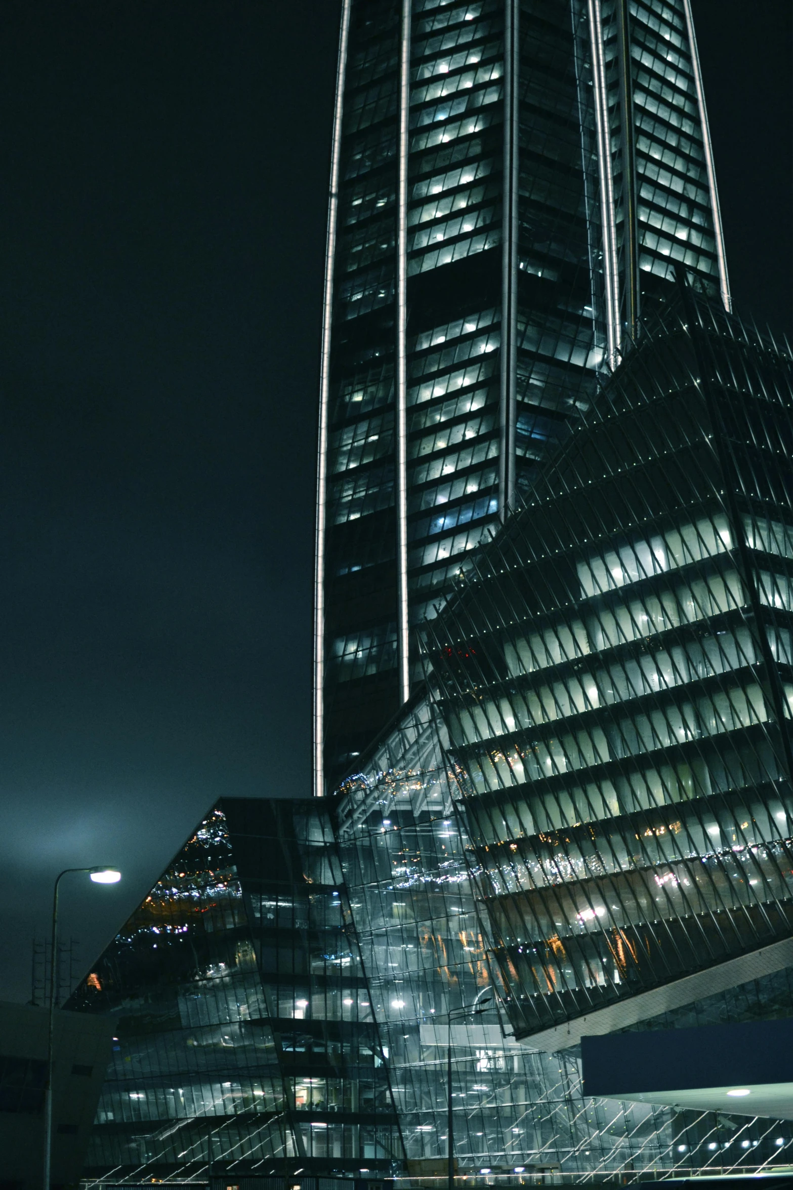 the top of the building at night with the lights on