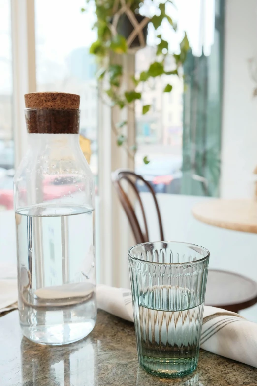 a glass with a brown cork on top of it