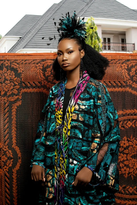 a woman wearing an ugly coat standing against a screen