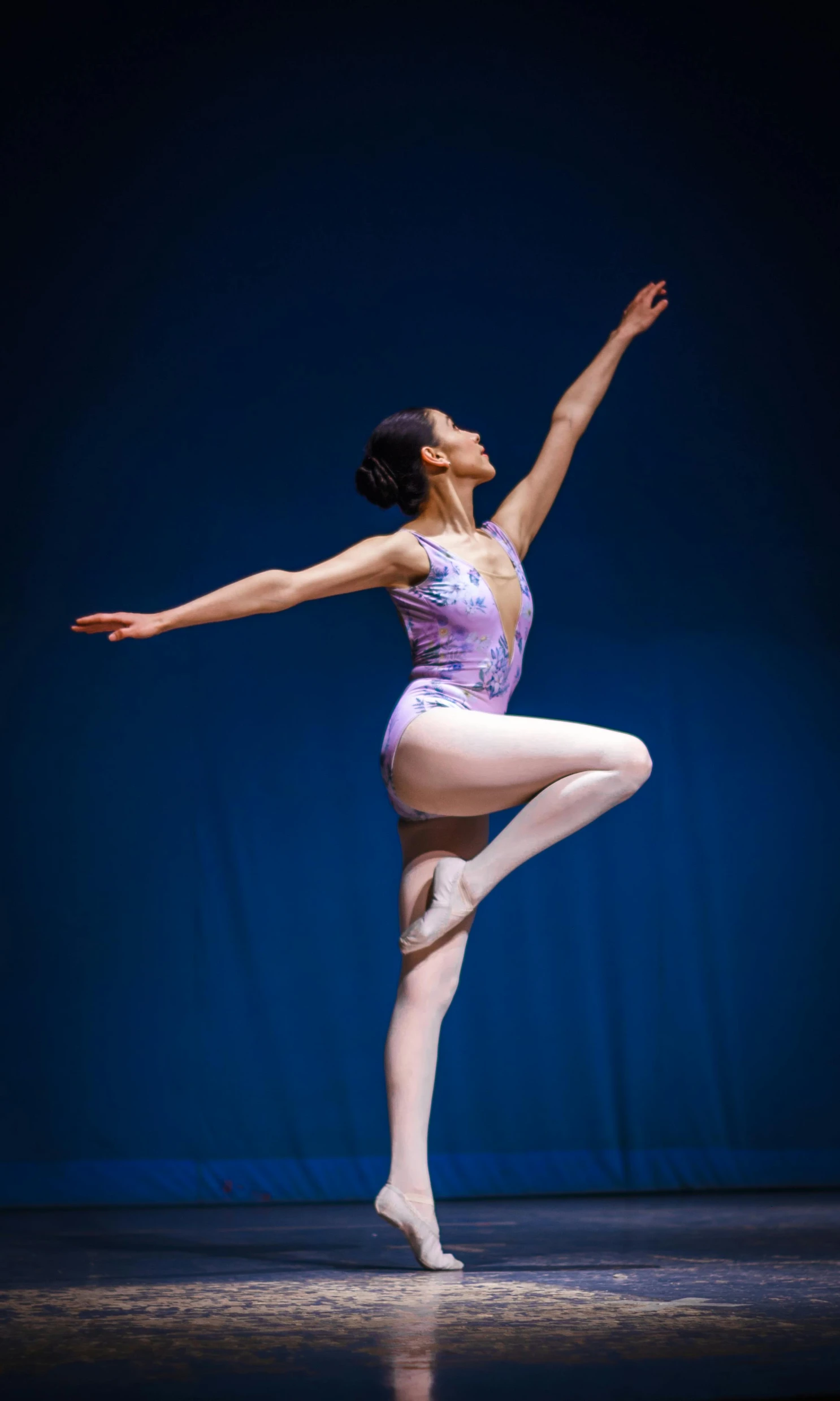 dancer is posing while holding up her leg