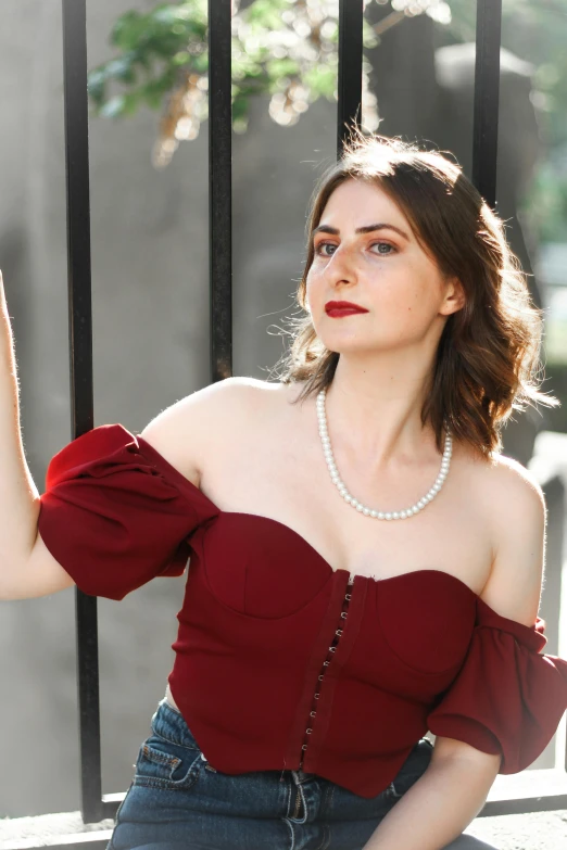 a woman with large  posing against a black fence