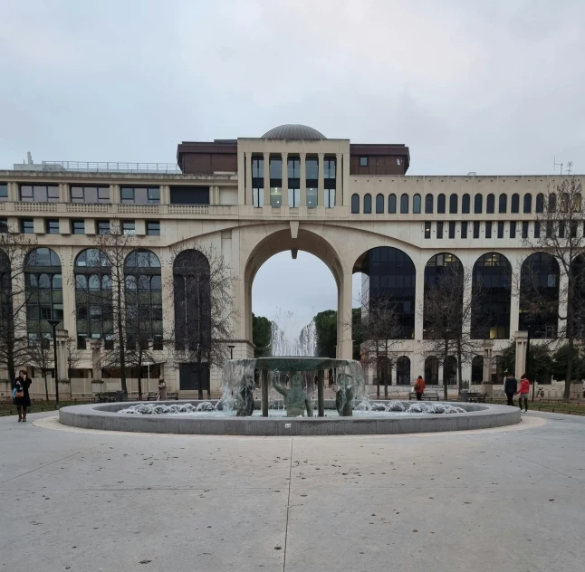 there are arches, buildings and water features on the courtyard