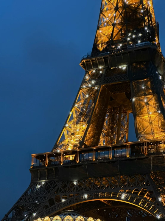 the eiffel tower illuminated in gold and silver