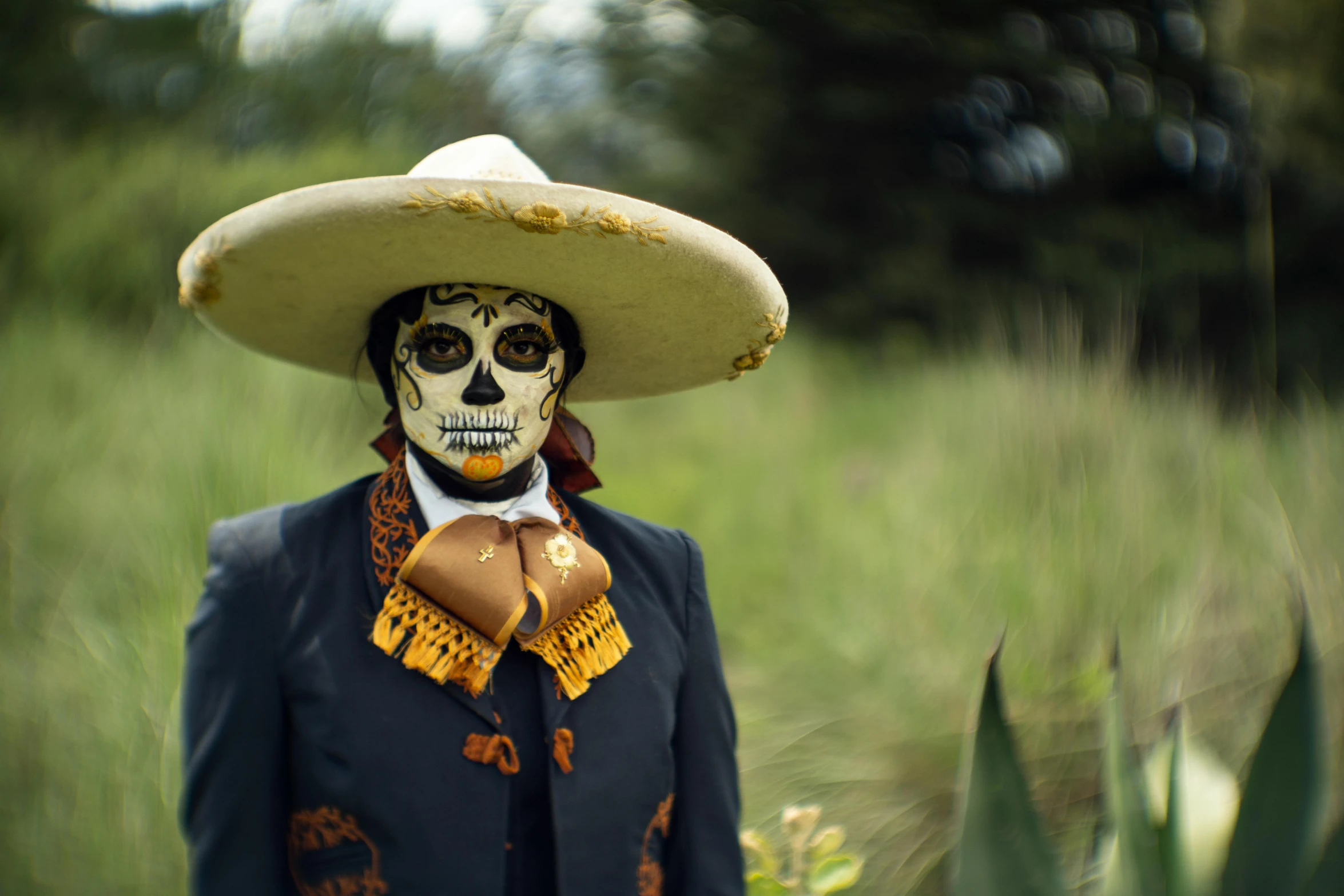 a skull dressed up as a mexican character in a field