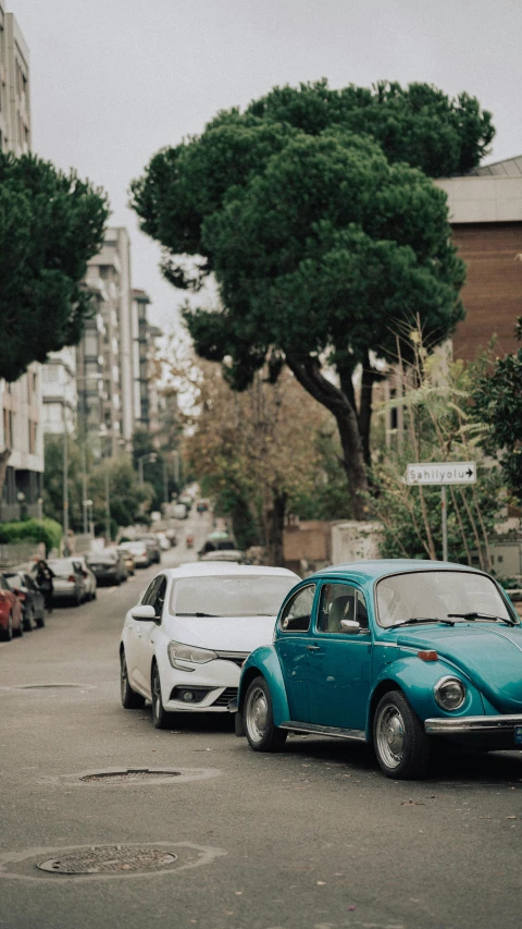 a vw beetle is being towed by a other bug