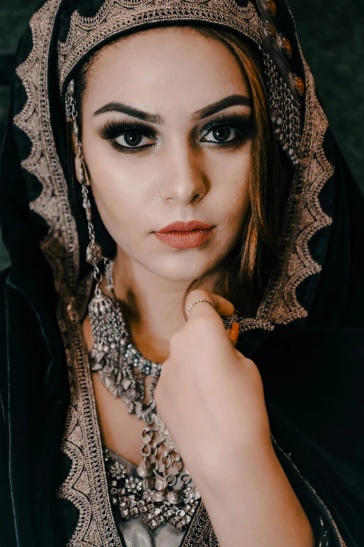 a woman in a hijab and veil poses for a portrait