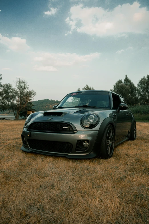 an old car is sitting in the middle of a field