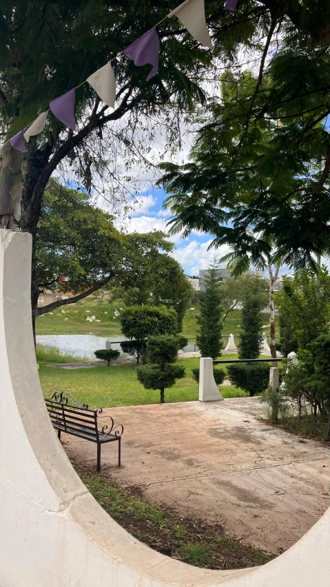 the view from an arch with a bench on it