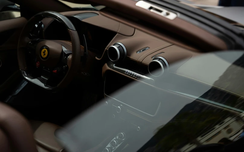 a brown leather car dashboard and steering wheel